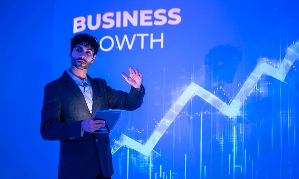 Presenter with business growth chart representing ASEAN capital-market expansion